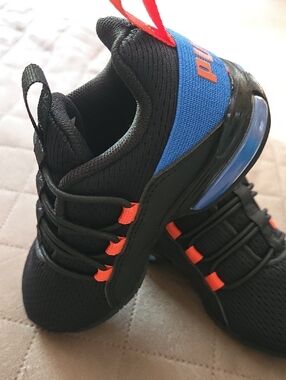 Puma Kids Black Sneakers with Blue and Orange Accents